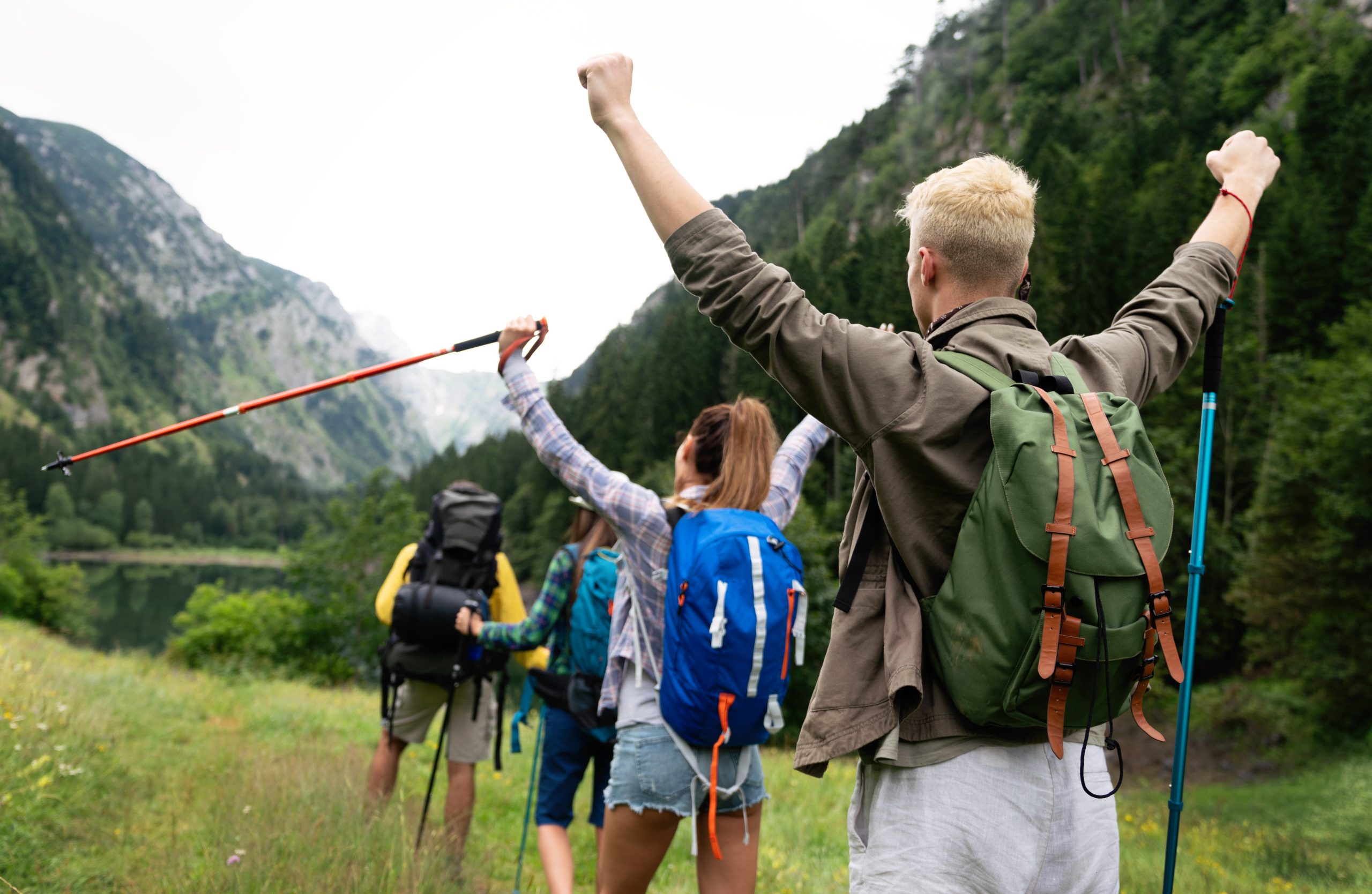 Group of friends hiking together outdoors exploring the wilderness and having fun